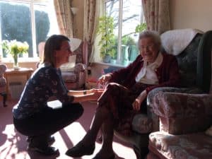 Doctor speaking to resident in a care home